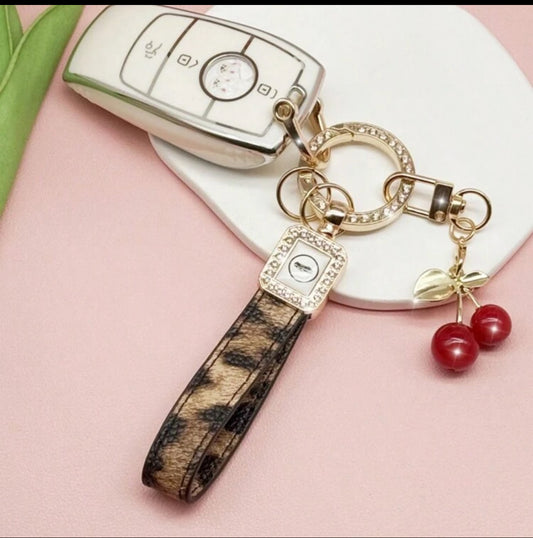Exquisitely Crafted Leopard Print Leather Car Key Chain With Adorable Cherry Pendant